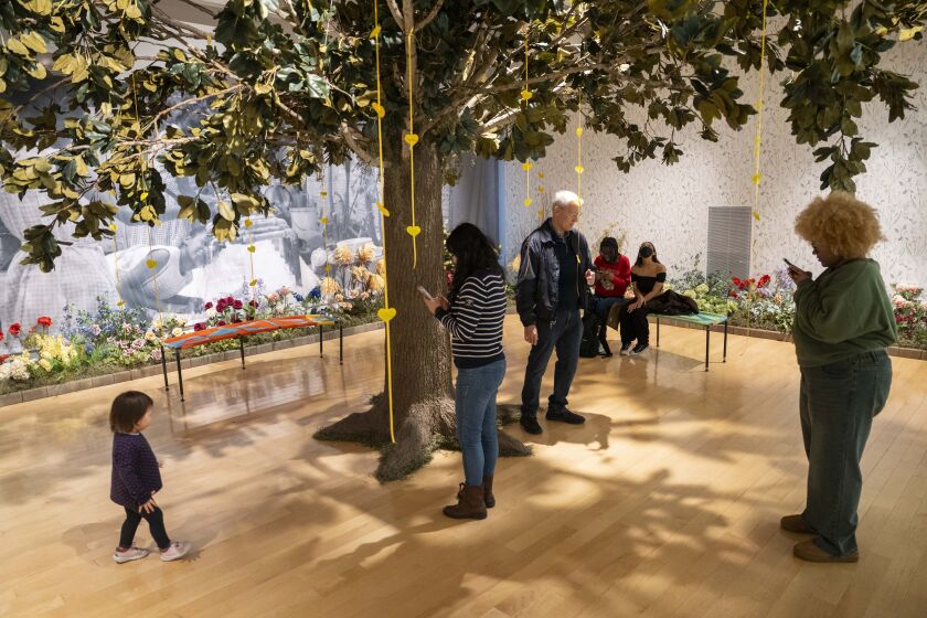 Visitors on Saturday take in“Rest and Recess: The Courtyard” part of the exhibit “Freedom Square: The Black Girlhood Altar” by artists Scheherazade Tillet and Robert Narciso.