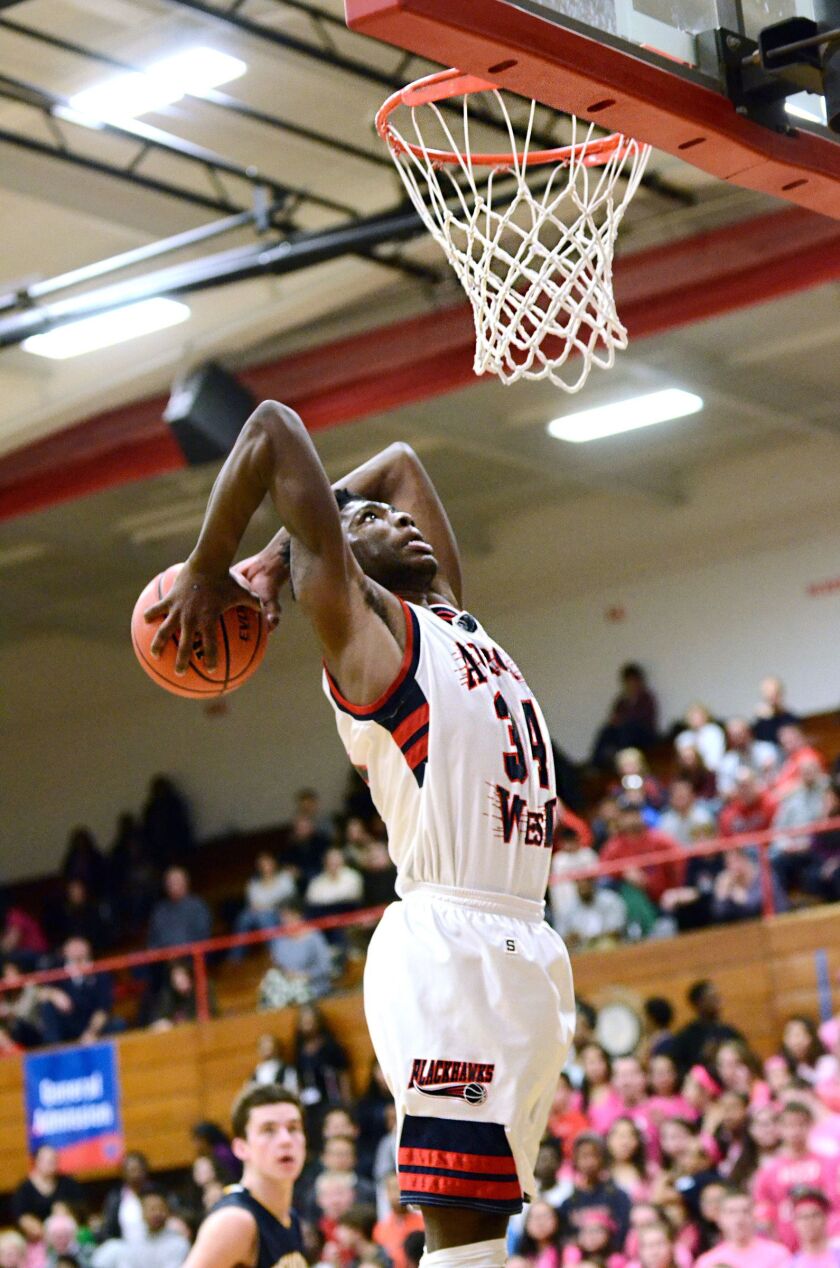 West Aurora’s Roland Griffin (34) goes up for the dunk.