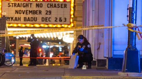 Chicago police investigate the scene of a shooting outside the Chicago Theatre in the Loop, Friday, Nov. 21, 2025.