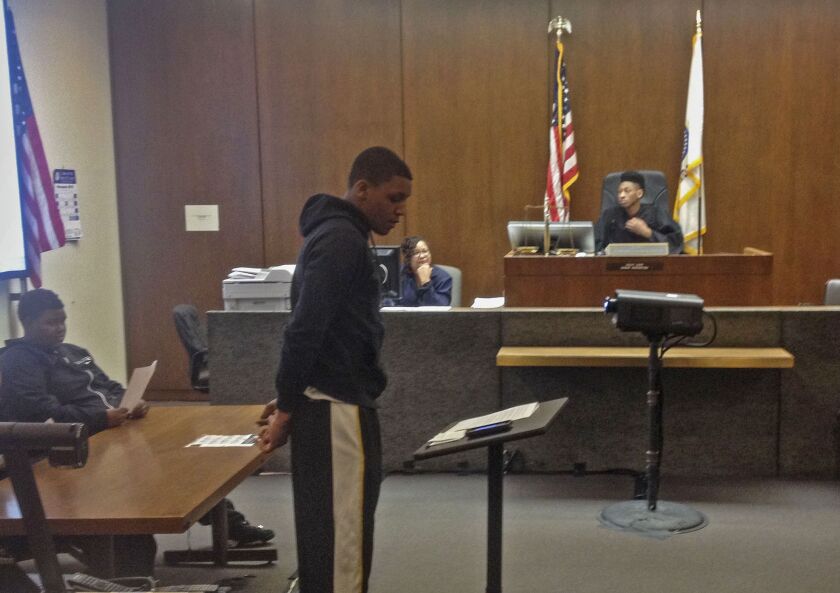 Simeon Academy basketball star Zach Norvell (at lectern) argues his case in a mock trial exercise as teammate Ben Coupet presides from the bench. | Mark Brown/Sun-Times