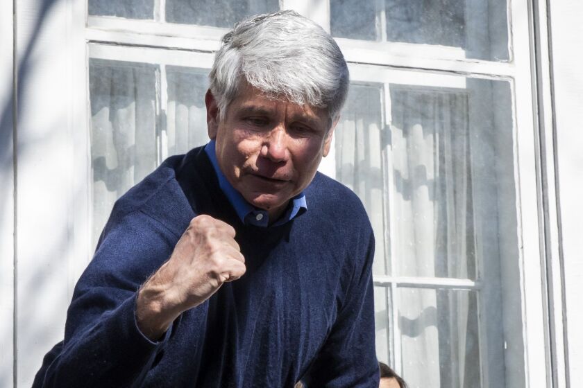 Former Illinois Gov. Rod Blagojevich greets supporters outside the family’s Ravenswood Manor home Wednesday.