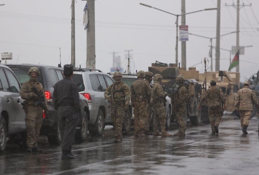 Foreign security personnel arrive at the site of an attack at the Marshal Fahim academy in Kabul, Afghanistan on Monday. | AP photo