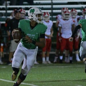 Notre Dame’s Anthony Sayles (7) rolls out for a pass against Marist. Worsom Robinson/For the Sun-Times.