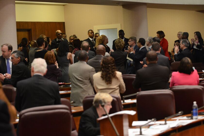 <small><strong>The Chicago City Council gives the survivors of police torture a standing ovation at Wednesday’s council meeting. | Brian Jackson/For The SunTimes</strong></small>