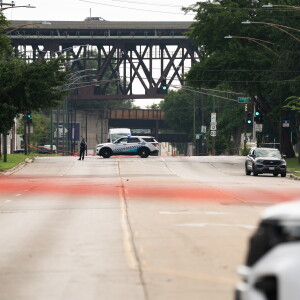 Police officers block off part of East 95th Street near South Escanaba Avenue in South Deering on the Far South Side on August 7, after 57 decomposing bodies were found in South Chicago Chapel, a funeral home, the night before.