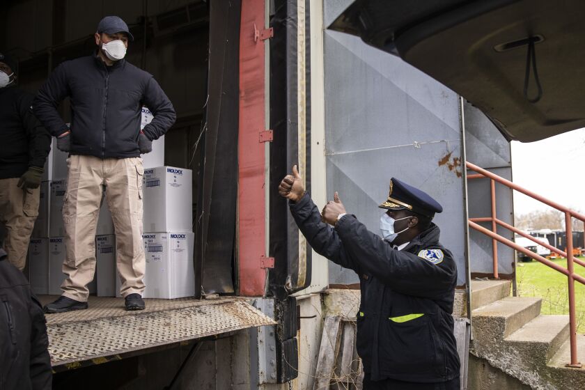 Hazel Crest Police Chief Mitchell Davis gives a thumbs up to officers with the Cook County Department of Emergency Management and Regional Security.