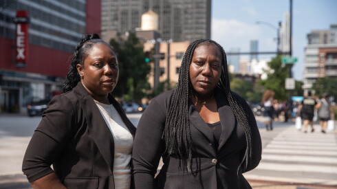 Sisters Kesha Thompson-Warren and Courtney Thompson stand next to each other outside, along East Cermak Road.