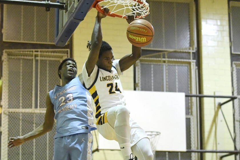 Lincoln Park's Larry Harris (24) dunks against Kenwood’s TJ Seals (23).