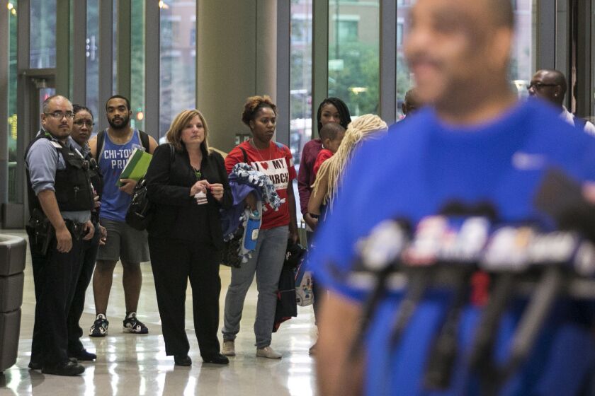 Chicago Police Supt. Eddie Johnson’s family watches as he addresses the media before kidney transplant surgery at Rush University Medical Center on Wednesday morning. Johnson’s 25-year-old son, Daniel, Johnson (blue tank top) is donating a kidney to his f