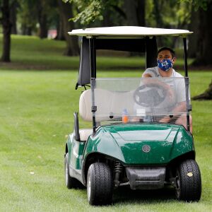 Mount Carmel golf coach Anthony Massino looks on from his golf cart during practice at Jackson Park Golf Course.
