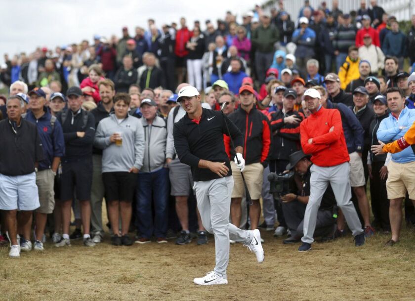 Brooks Koepka of the United States plays out of the rough on the 15th hole during the first round of the British Open Golf Championship. | Peter Morrison/Associated Press