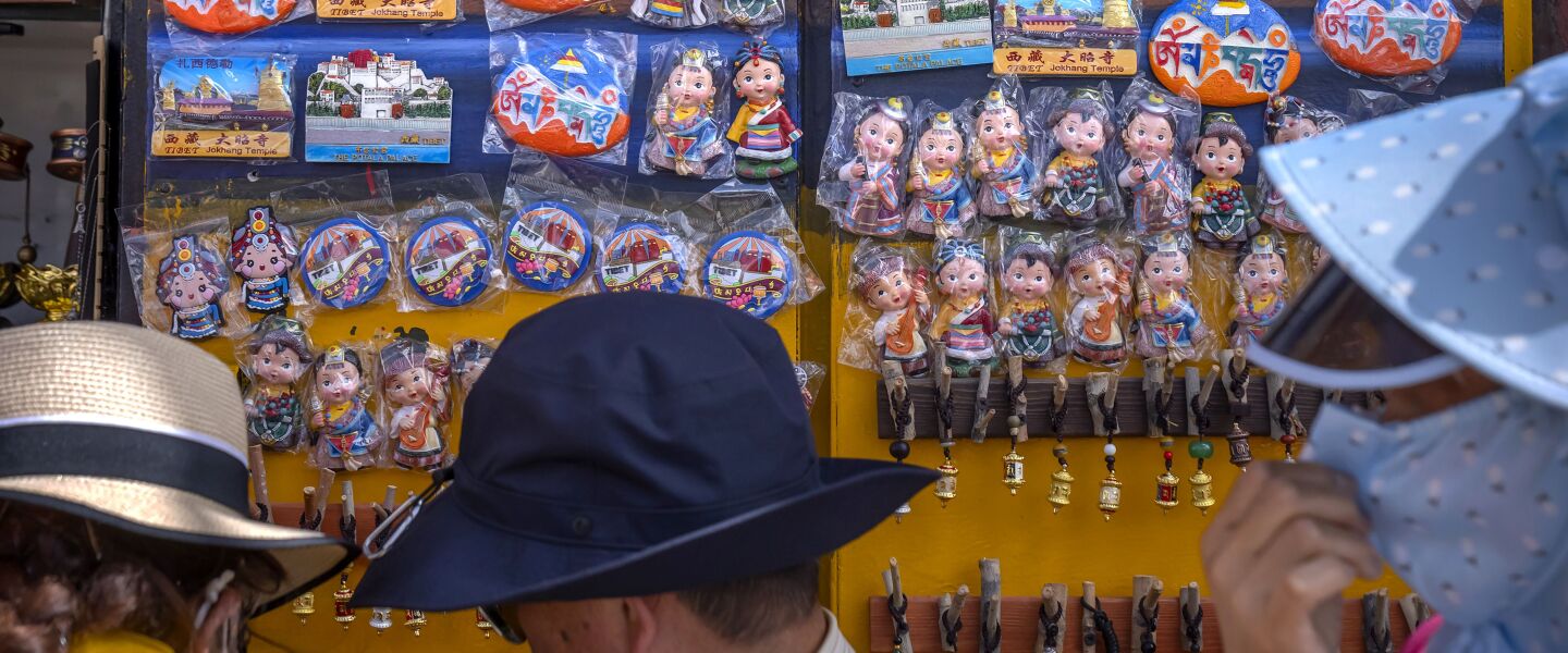Tourists look at merchandise for sale at a souvenir shop outside of the Jokhang Temple in Lhasa in western China’s Tibet Autonomous Region.