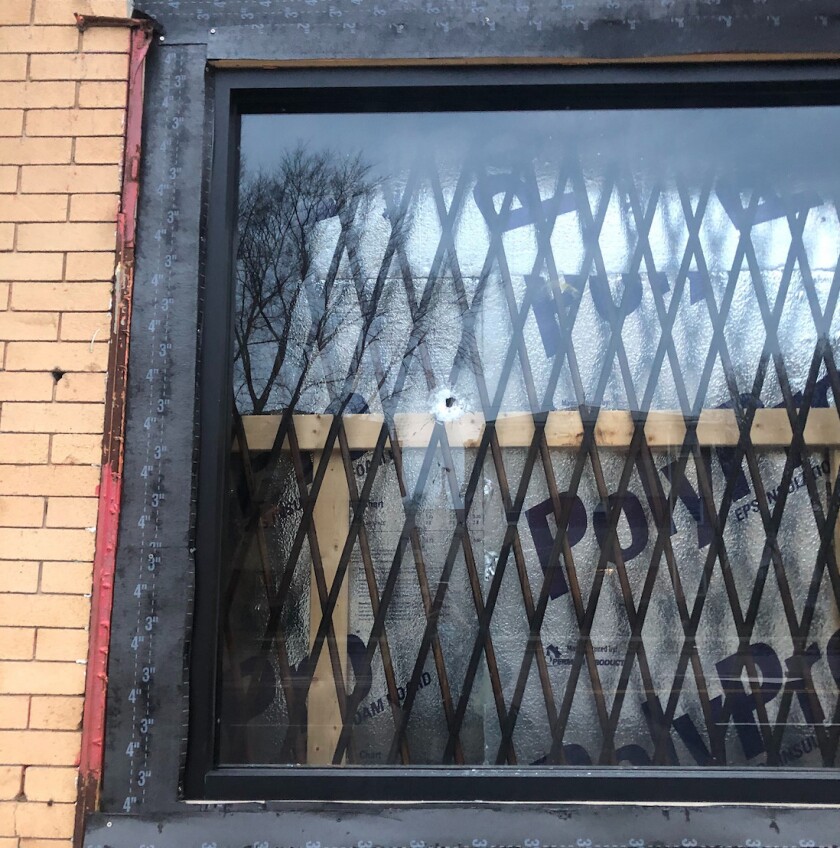 A bullet hole could be seen in the window of the Get Glammed Beauty Bar.