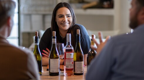 Audrey Witte, general manager at Kouklas Greek Eatery in Niles, chats with wine distributors during a tasting.