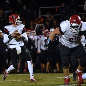 Yorkville’s Josh Beetham (8) looks for a receiver. Worsom Robinson/For the Sun-Times.