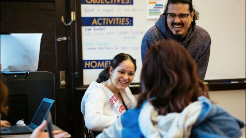 Josh Zepeda, a social worker at Sullivan High School in Rogers Park, shares a laugh with students in a class for those who speak little or no English.