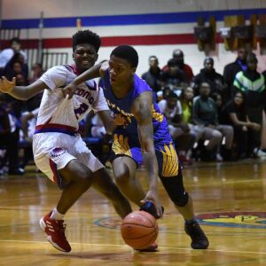 Curie’s Damari Nixon (2) fouls Simeon’s Kejuan Clements (0). Worsom Robinson/For the Sun-Times.