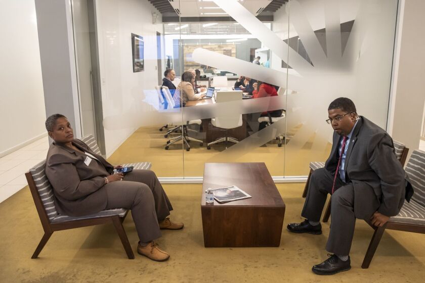Two members of Cook County Board President Toni Preckwinkle’s security detail wait as she met with the Sun-Times’s editorial board in October.