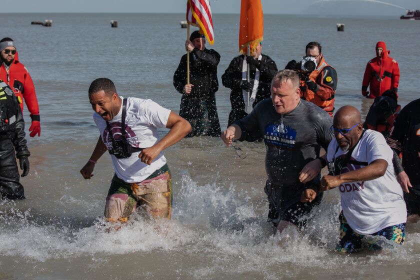 (From left) “Today” show anchor Craig Melvin, Jon Harris and “Today” show weather forecaster Al Roker take a dip in Lake Michigan during the 20th Polar Plunge at North Avenue Beach, Sunday morning, March 1, 2020. Nearly 5,000 people attended Special Olympics Chicago’s largest fundraising event.