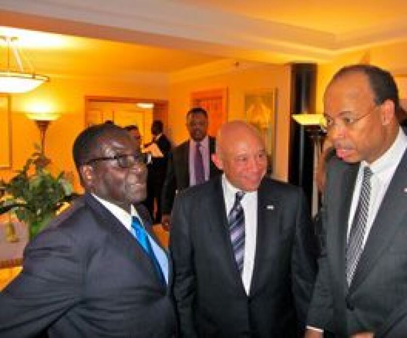 From left, Zimbabwe President Robert Mugabe, Chicago businessman Elzie Higginbottom and former U.S. Rep. Mel Reynolds in New York City in September 2011. | Supplied photo