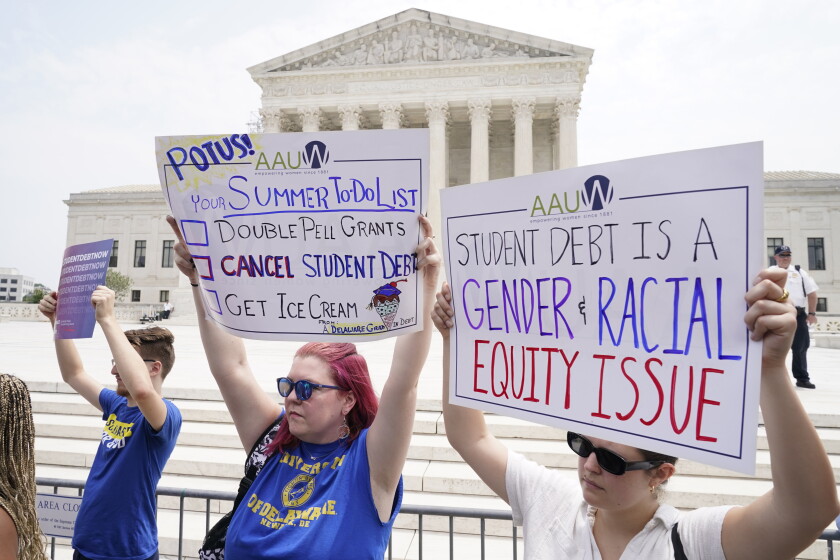 Demonstrators stand outside the Supreme Court in 2023 calling for student loan debt relief.
