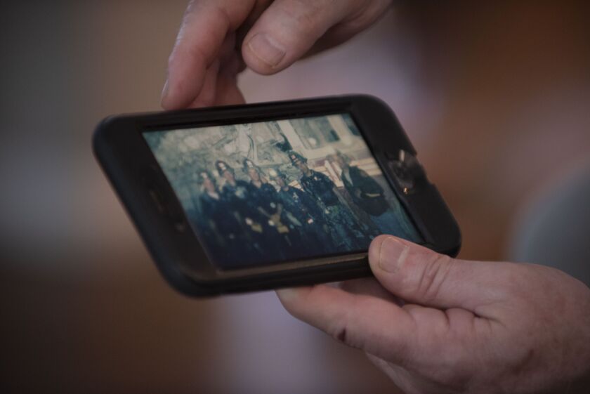Chicago Fire Department Battalion Chief Pat Maloney shows an image of himself and fellow first responders at the scene of the 9/11 attacks 17 years ago. | Colin Boyle/Sun-Times