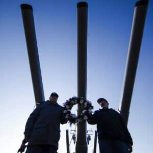 Navy Veterans Joe Low, left, and Al Villalobos carry a wreath during a Pearl Harbor ceremony. | AP Photo