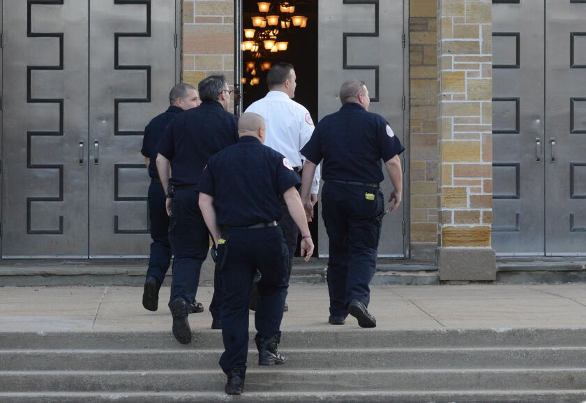 Firefighters enter St. Rita to pay their respects to the family of Daniel Capuano. | Brian Jackson/For the Sun-Times