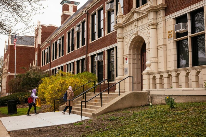 Students arriving at Sullivan High School in Rogers Park, which for years has served large numbers of immigrant and refugee students. It has undergone dramatic changes with a big rise this year in the number of new students arriving from Afghanistan.