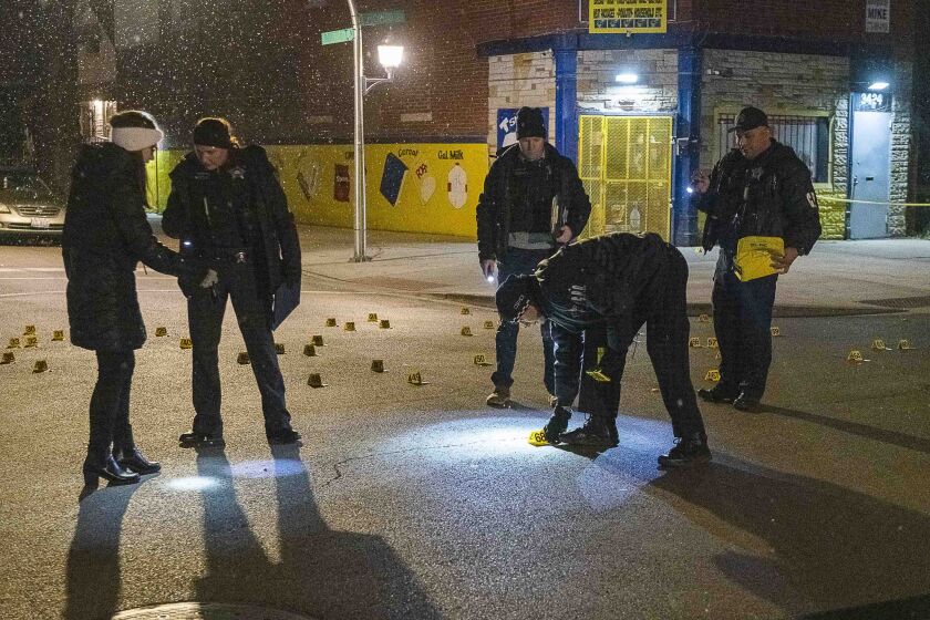 Chicago police investigate a scene where three people where wounded in a shooting Friday night in the 3400 block of West Ohio Street. | Tyler LaRiviere/Sun-Times