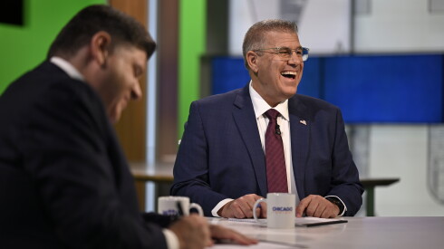 Republican nominee Darren Bailey laughs beside Democratic Gov. JB Pritzker before the start of the televised WTTW News Gubernatorial Forum on Tuesday, Oct. 13, 2026.