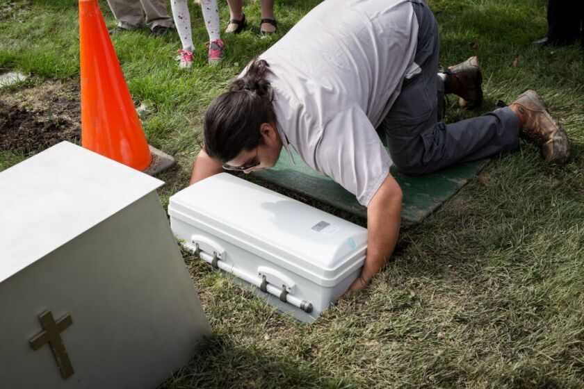 Cemetery worker David Santos places Jazlene’s casket in its final resting place at All Saints Cemetery in Des Plaines. | Santiago Covarrubias/Sun-Times