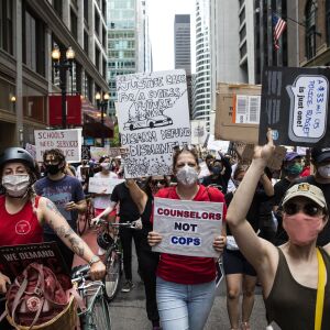 Chicago Teachers Union members and hundreds of supporters march through the Loop to call for the Chicago Board of Education to vote to end a $33 million contract between Chicago Public Schools and the Chicago Police Department, Wednesday afternoon, June 24, 2020.