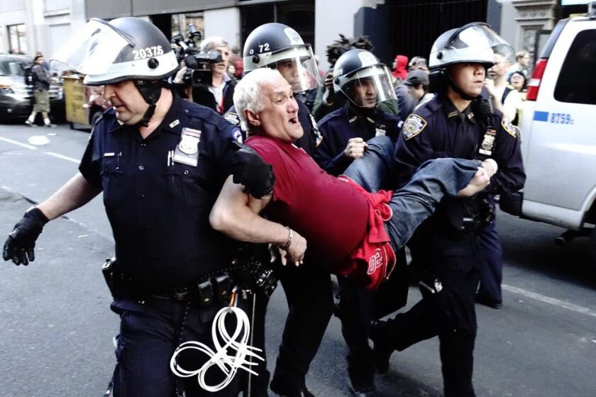<small><strong>A demonstrator is arrested by police officers during a protest April 29, 2015 at Union Square in New York, held in solidarity with demonstrators in Baltimore, Maryland demanding justice for an African-American man who died of severe spinal