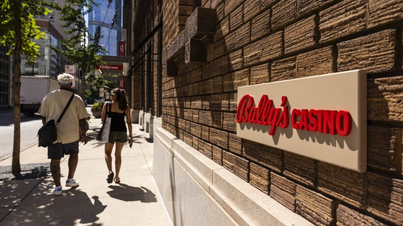 People walk by the site of the Bally’s temporary casino at Medinah Temple in River North.