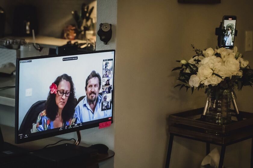This Sunday, Dec. 27, 2020 photo provided by Kristen Pritchard Photography shows friends and relatives attending on Zoom during Kayleigh and Cody Cousins’ wedding in San Diego, California.