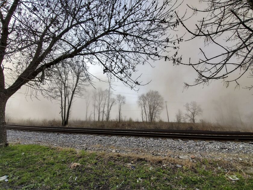 A cloud of dust spreads across the Little Village neighborhood after the Crawford power plant smokestack was imploded in April 2020.
