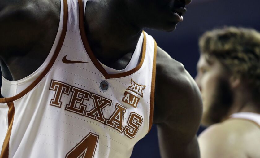 Texas forward Mohamed Bamba (4) wears an “AJ1” logo on his jersey against TCU on Wednesday, Jan. 10, 2018, in Austin, Texas. The players are wearing the logo to support teammate Andrew Jones, who has been diagnosed with leukemia. | Eric Gay/AP
