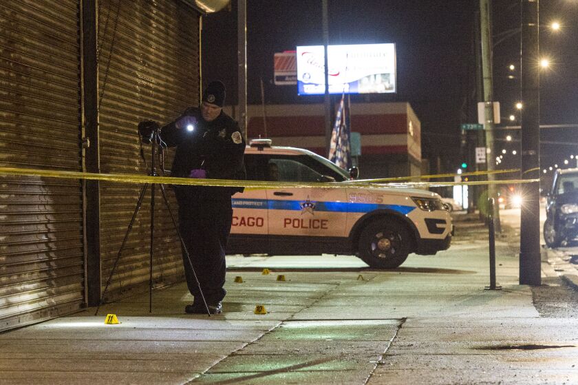 Officers investigate the scene where a girl was shot Monday evening in the 7400 block of Ashland. | Tyler LaRiviere/Sun-Times