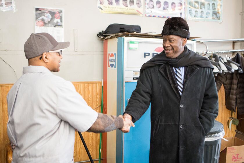 Mayoral candidate Willie Wilson shakes hands with Herb Harrington at Herb’s Barbershop in the Austin neighborhood, on election day, Tuesday, February 24th. | James Foster / for Sun-Times Media