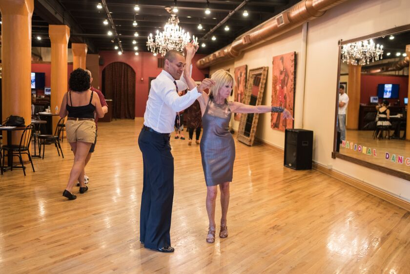 Sandy Mandel dances with instructor Drew Sutherland at Arthur Murray studio in River North on July 18, 2017. | Max Herman/For the Sun-Times