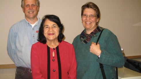Three people, a man and two women, pose for a photo.