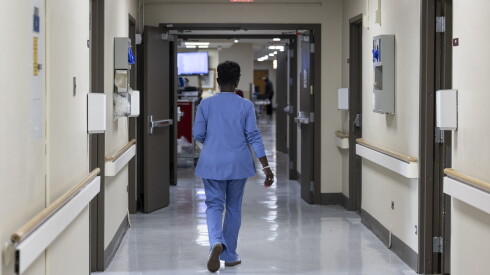 A health care worker walks down the hallway in the Acute Care Unit at Roseland Community Hospital.