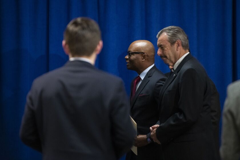 David Brown, center, walks with acting police Supt. Charlie Beck in April 2020 after Brown was selected as the next superintendent.