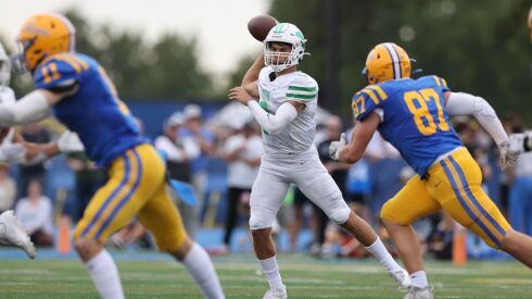 York’s Matt Vezza (9) steps forward in the pocket and throws a pass against Lyons.