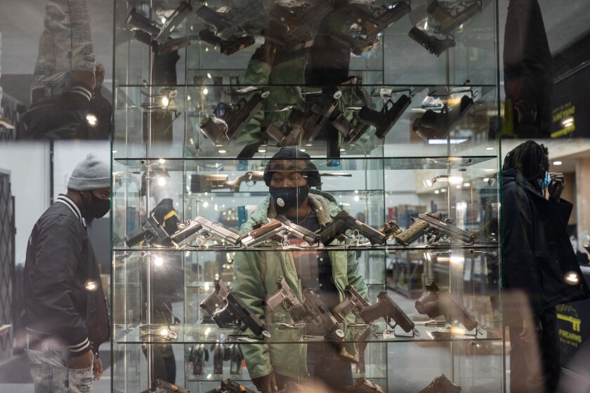 Customers browse for guns at Kee Firearms and Training in New Lenox in January.