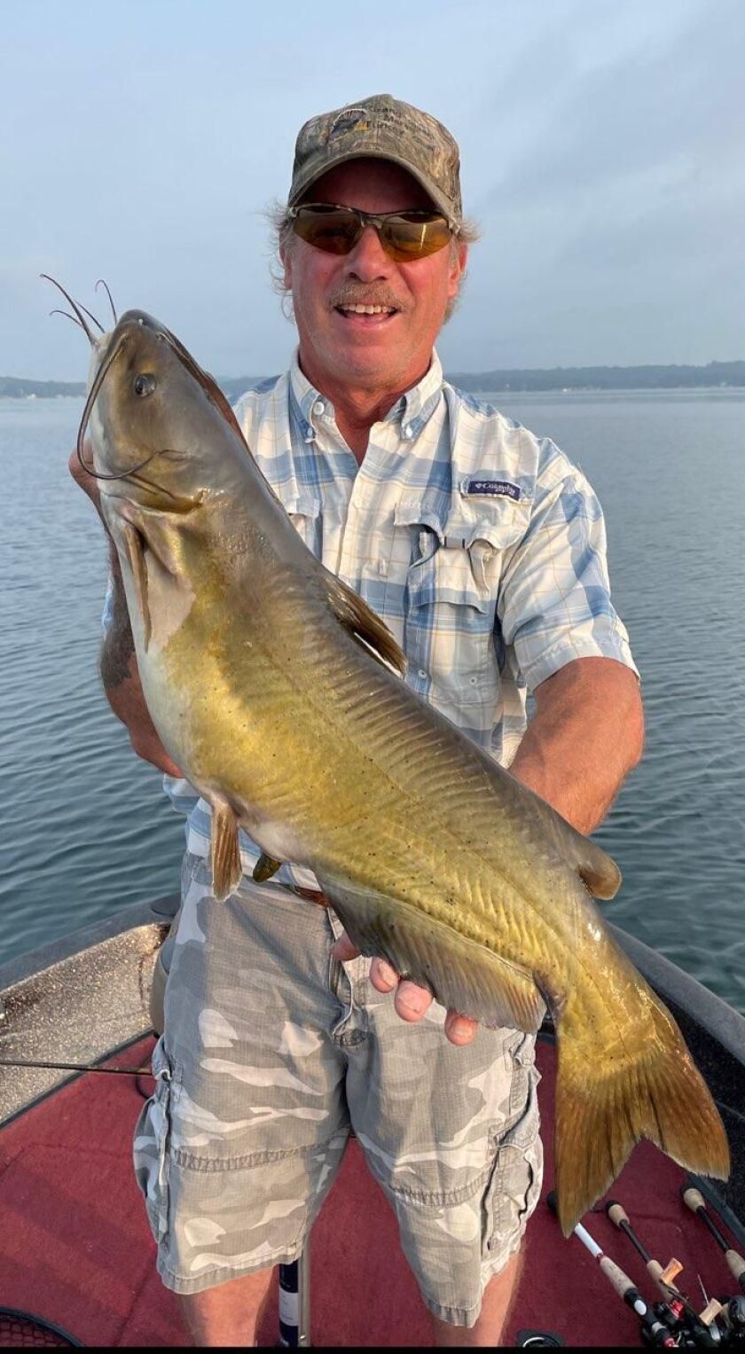 Duane Langenwalter with the surprise of a big catfish while bass fishing Big Green Lake. Provided by Mike Norris
