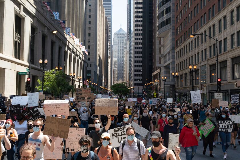 Demonstrators people march Saturday in the Loop during the Boycott 4th of July rally against police brutality.