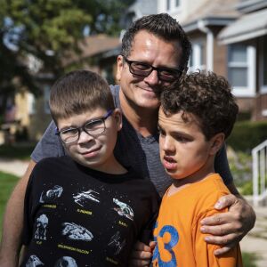 Oliwier “Oli” Kluzik (left) and Dorian Stepniewski pose for a portrait with their uncle Marek Kalinowski (center) on the Northwest Side.