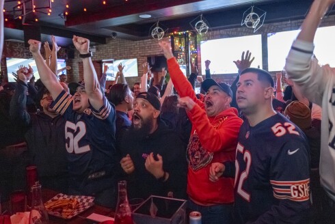 Fans at Everything Bar in West Town celebrate after the Bears score their winning touchdown during the fourth quarter of Saturday's game against the Green Bay Packers.